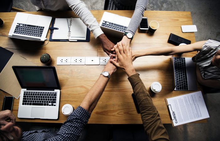 Team of business people stacking hands